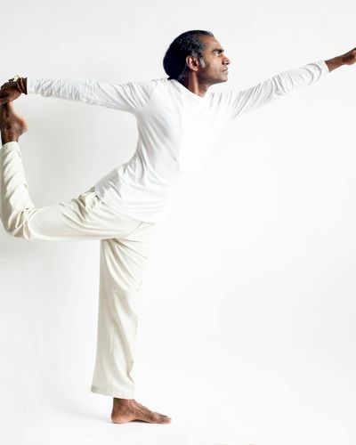 Man stretching his arms in a bright studio